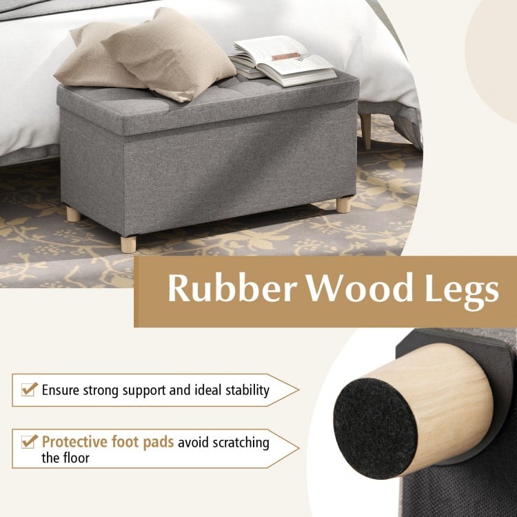 Close-up of the rubber wood leg of the gray storage ottoman bench, featuring protective foot pads to avoid floor.