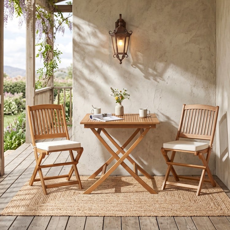 32-inch square solid teak wood patio dining table with two folding chairs, perfect for intimate outdoor dining.