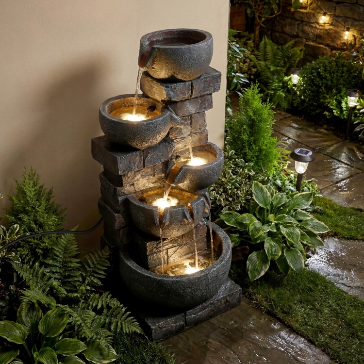 Five-tier outdoor water fountain with LED lights, gray stone finish, creating a calming ambiance for patios.