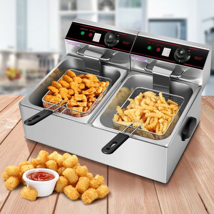 Dual tank electric countertop deep fryer with stainless steel construction, featuring two baskets for versatile cooking.