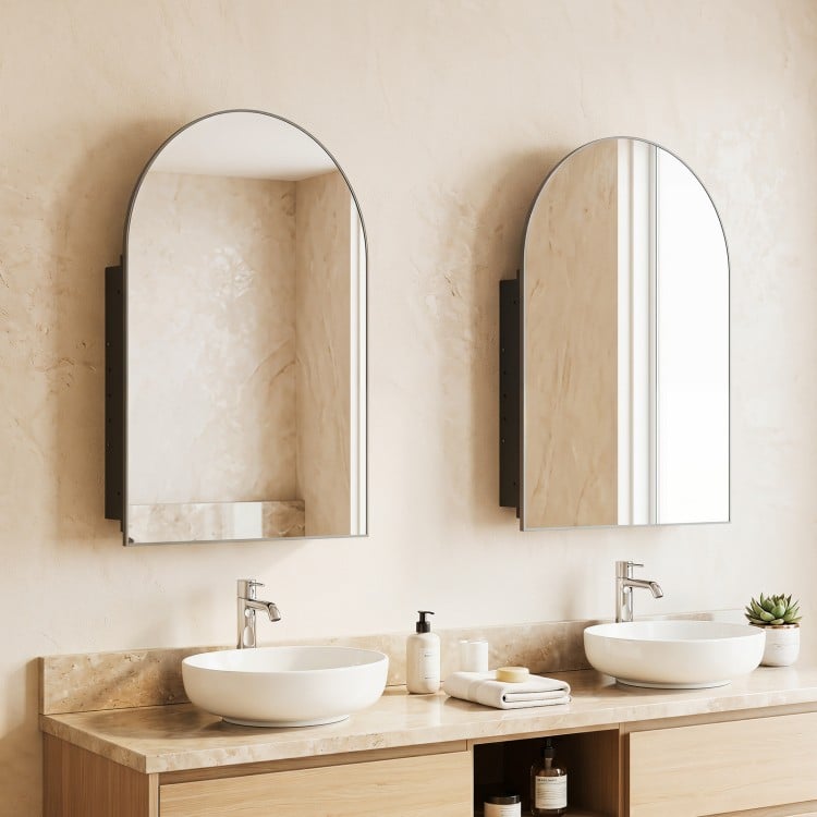 Brushed metal wall-mounted storage cabinet with arched mirror, featuring adjustable tempered glass shelves for elegant bathroom decor.