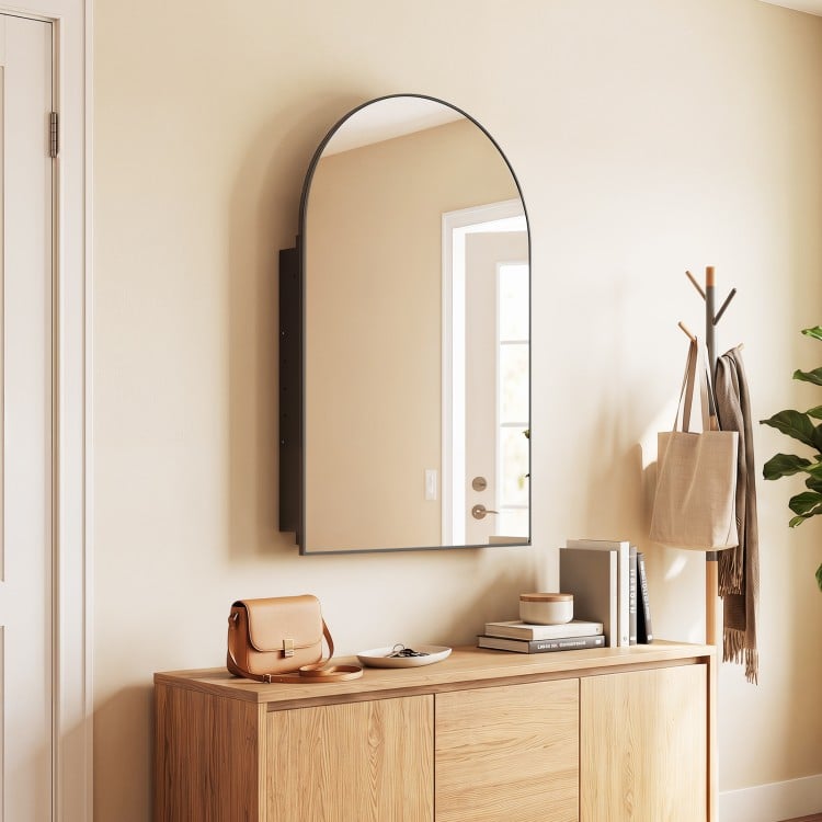 Arched mirror with brushed metal frame and adjustable shelves, perfect for wall-mounted storage in modern spaces.