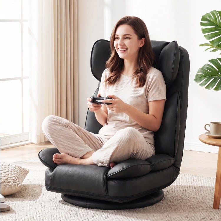 Black 360° swivel floor gaming chair with adjustable backrest, featuring sponge filling for comfort during long.
