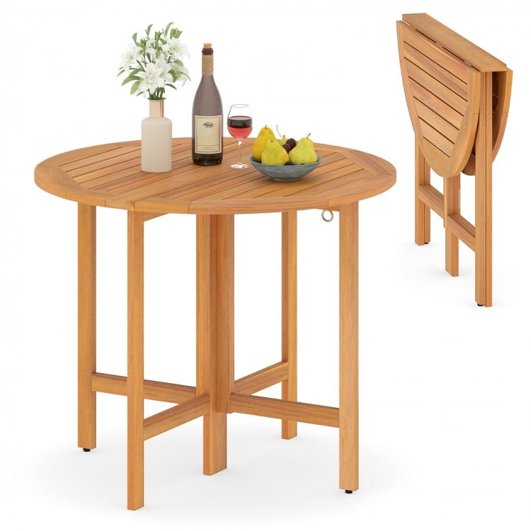 Round 36-inch outdoor folding dining table made of acacia wood, featuring a slatted tabletop, ideal for backyard.