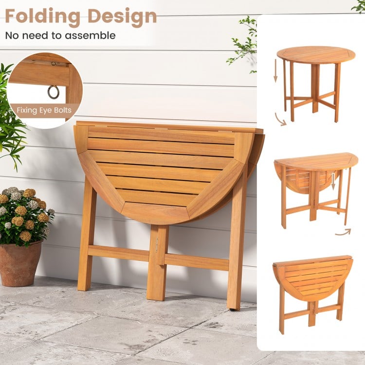 Outdoor folding round dining table made of acacia wood, featuring a slatted tabletop, ideal for backyard gatherings.