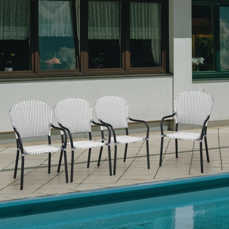 Set of 4 stackable patio dining chairs in white rattan with armrests, perfect for poolside or garden use.