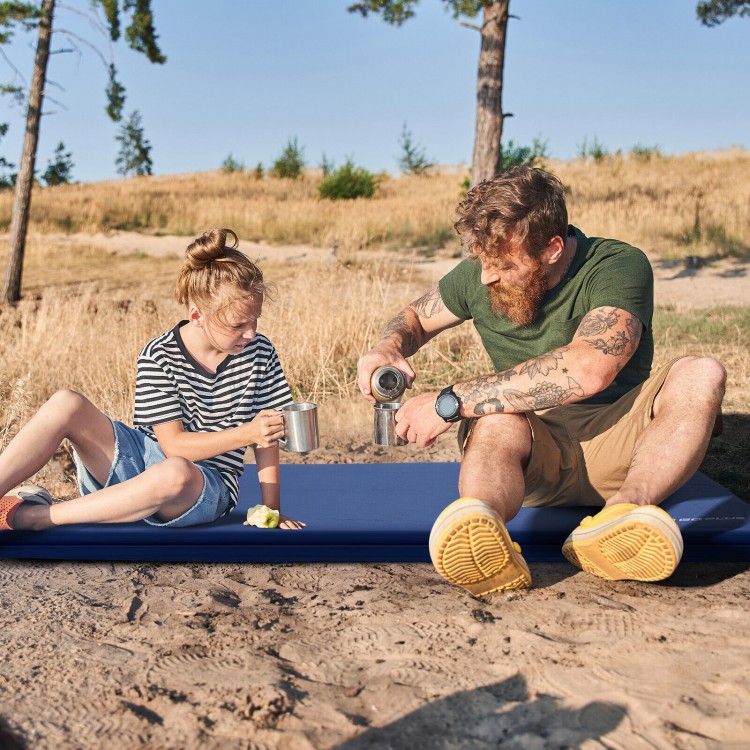 Self-inflating lightweight foam sleeping cot in blue, providing comfort and warmth for outdoor camping.