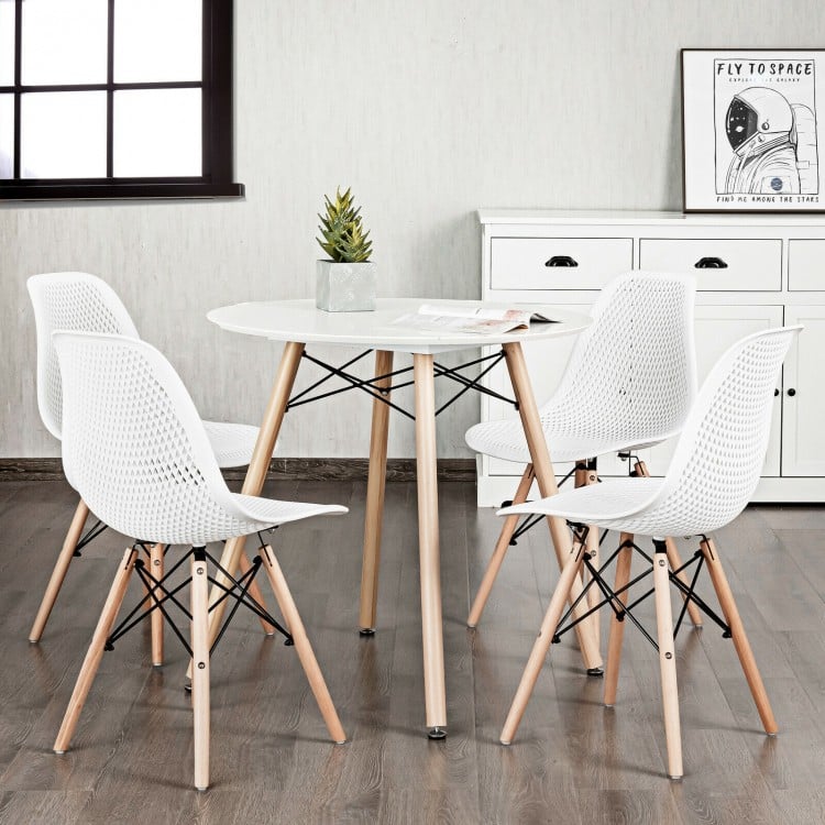 Modern plastic hollow chair set with wood legs in white, featuring ergonomic mesh design for breathability and comfort.