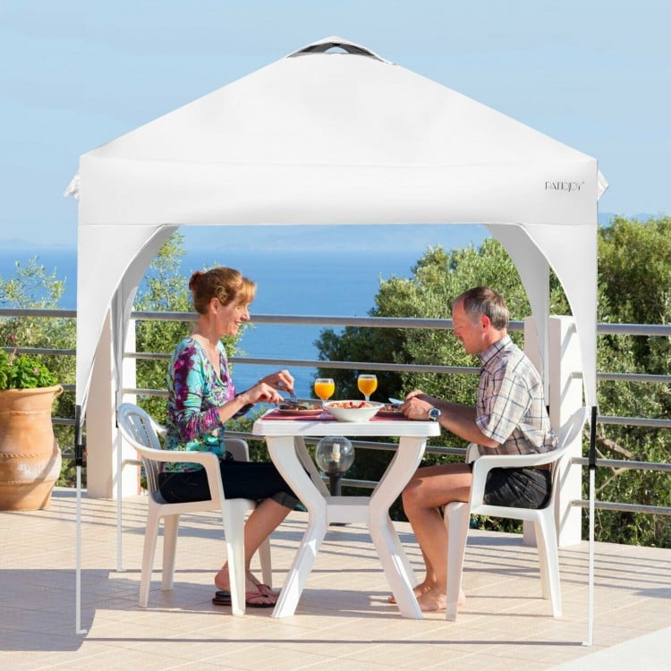 Pop up height adjustable canopy tent in white, providing 6.6'x6.6' shade for outdoor dining and activities.