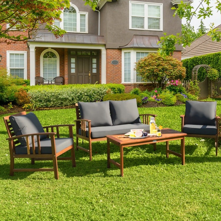 4-piece wooden patio furniture set featuring a sofa and chairs with soft cushions, perfect for outdoor relaxation.