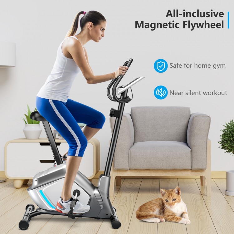 Upright magnetic exercise bike with adjustable seat, LCD monitor, and pulse sensor for home gym workouts.