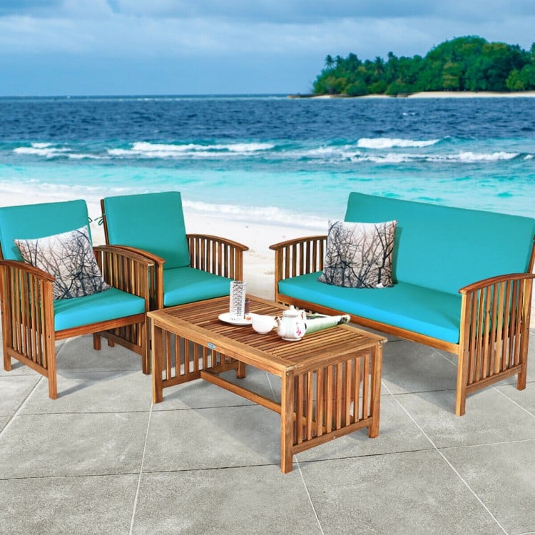 4-piece patio furniture set in blue with acacia wood frame, soft cushions, and coffee table for outdoor relaxation.