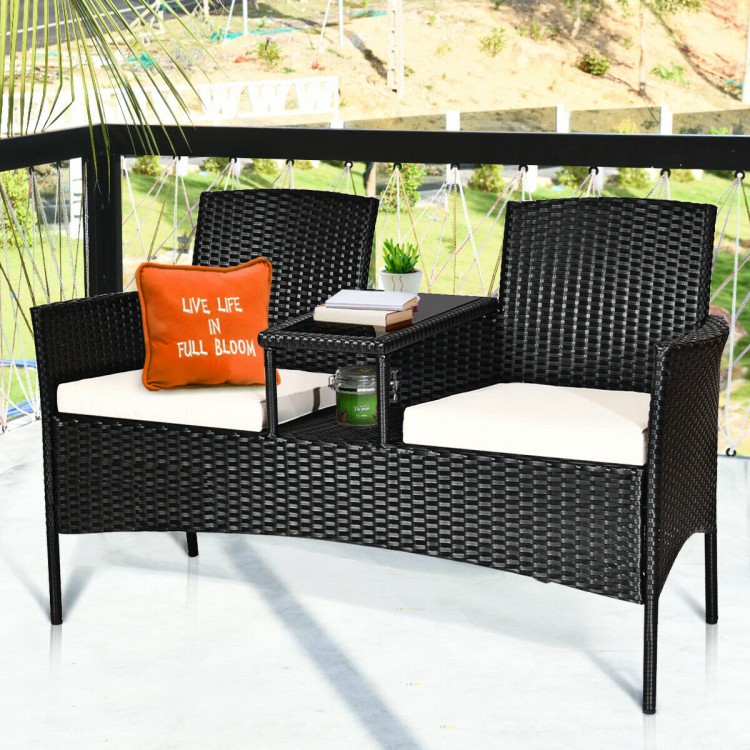 Wicker patio conversation set with removable cushions, featuring a tempered glass table, ideal for garden or balcony.