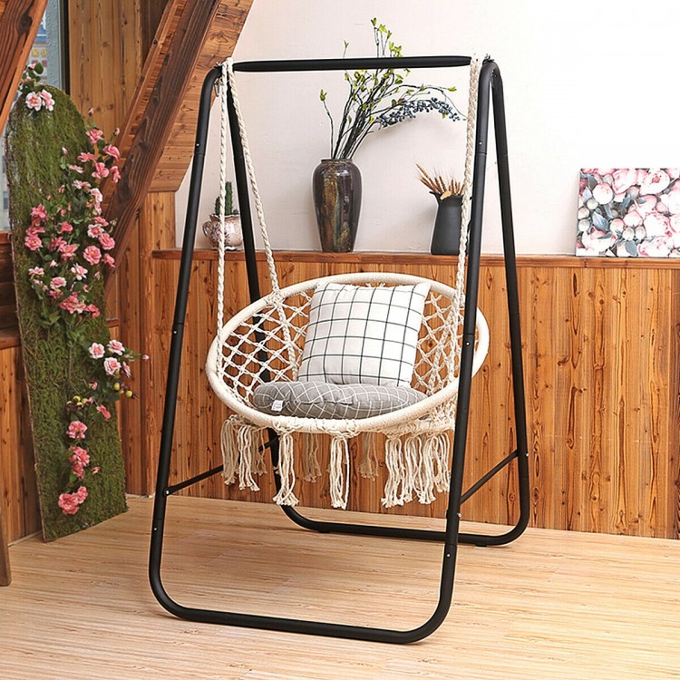 Hanging macrame hammock chair with handwoven cotton backrest, supported by a sturdy metal frame for indoor or outdoor.