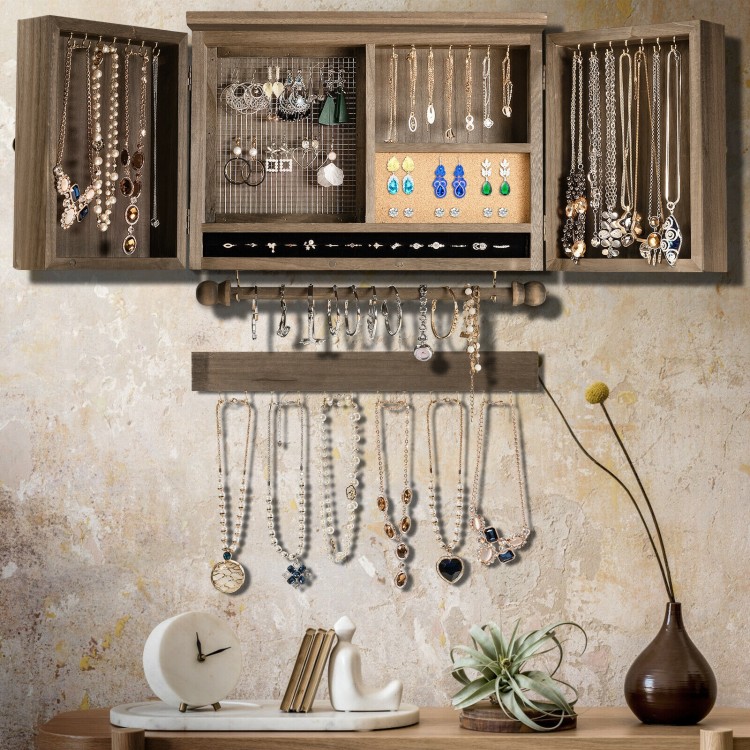 Vintage wood wall-mounted jewelry organizer with barn doors, featuring multiple hooks and a padded slot for rings.