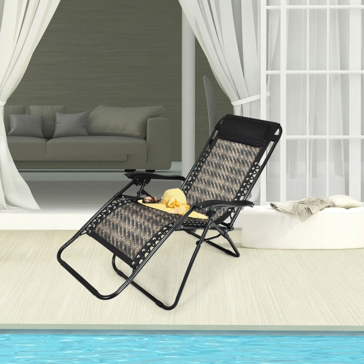 Folding rattan zero gravity lounge chair in gray with removable head pillow, perfect for outdoor relaxation by the pool.