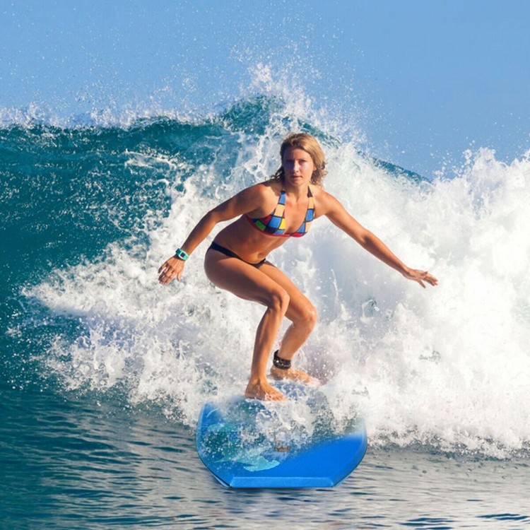 Surfer riding a wave on a lightweight blue bodyboard with EPS core, ideal for outdoor water sports and summer fun.