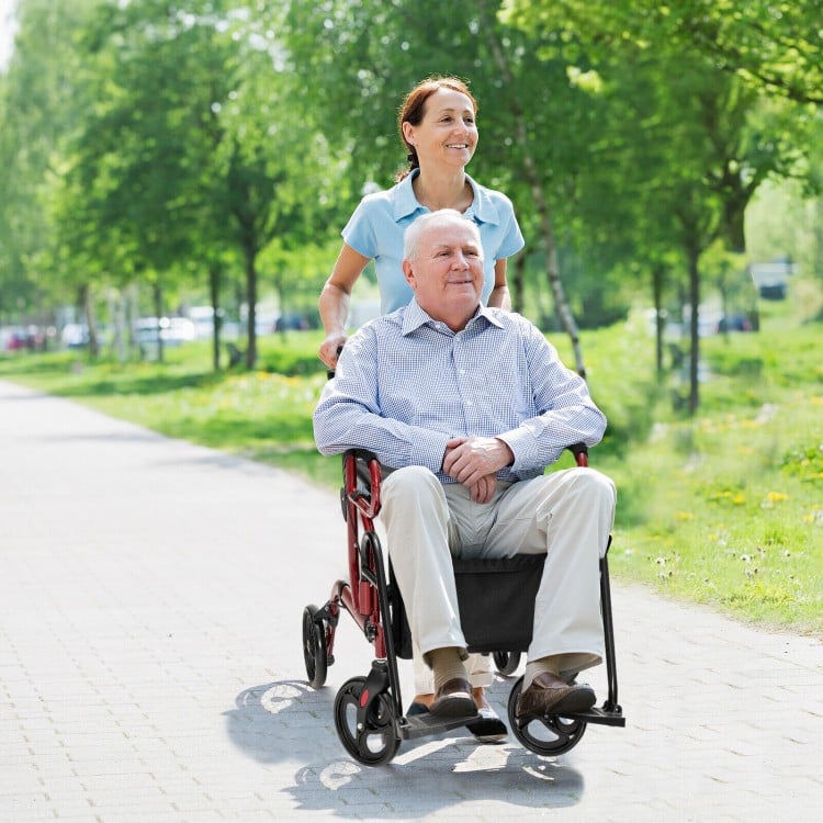 Folding rollator walker in red with 8-inch wheels, used as a wheelchair for mobility support and comfort.