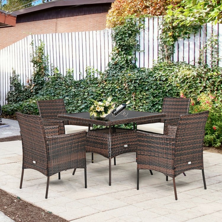 Outdoor 5-piece dining table set featuring 1 table and 4 rattan sofas with cushions, ideal for patio gatherings.