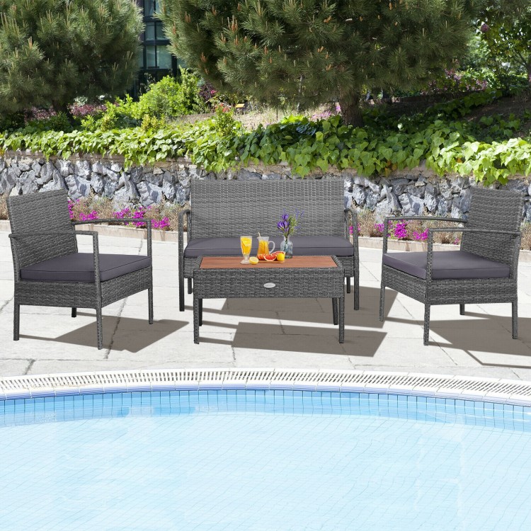 4-piece rattan patio conversation set with acacia wood tabletop, featuring 2 single sofas and a loveseat by the.