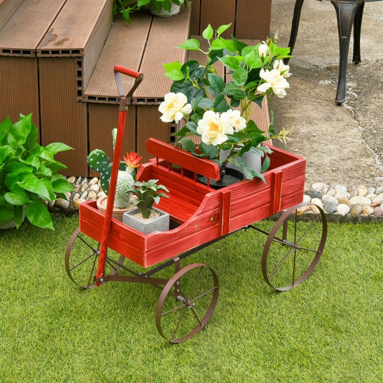 Red wooden wagon plant bed with wheels, featuring two planting sections, ideal for garden or patio decoration.