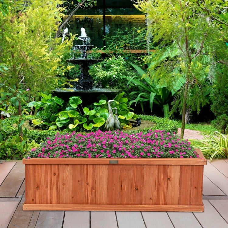 Wooden decorative planter box made of 100% natural fir, ideal for garden or window with vibrant flowers and drainage.