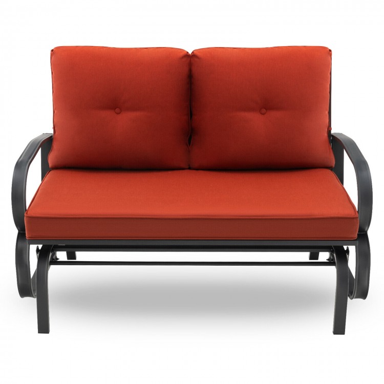 Brick red cushioned 2-person glider bench with ergonomic armrests and sturdy steel frame, ideal for outdoor relaxation.