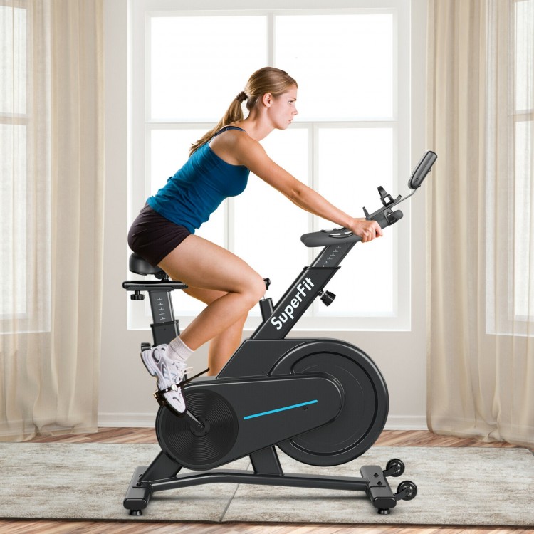Magnetic exercise bike with adjustable seat and handle, featuring LCD panel and smooth riding for home or gym use.