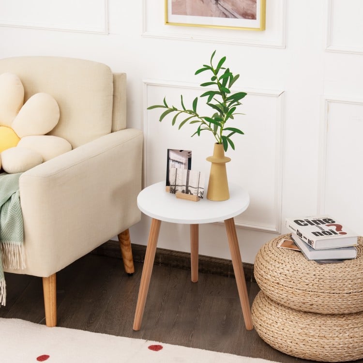 Stylish 16-inch round coffee table with a white MDF top and natural pine wood legs, perfect for accenting any cozy.