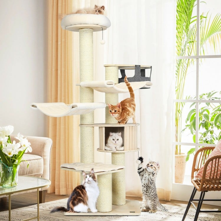 Multi-level cat tree condo in cream white with sisal posts, featuring cozy pads and playful fur balls for feline fun.