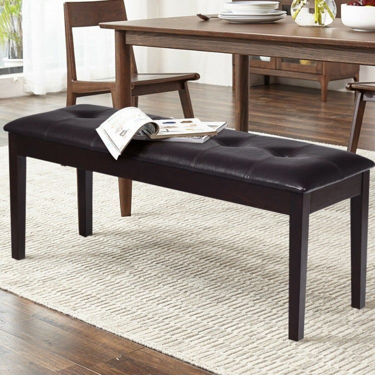 Brown upholstered dining room bench with button tufting, solid rubberwood legs, ideal for dining and multipurpose use.
