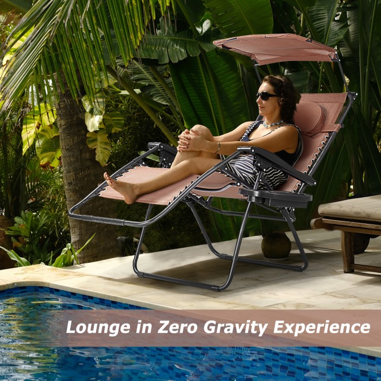 Folding recliner lounge chair with adjustable sun shade canopy, cup holder, perfect for outdoor relaxation by the pool.