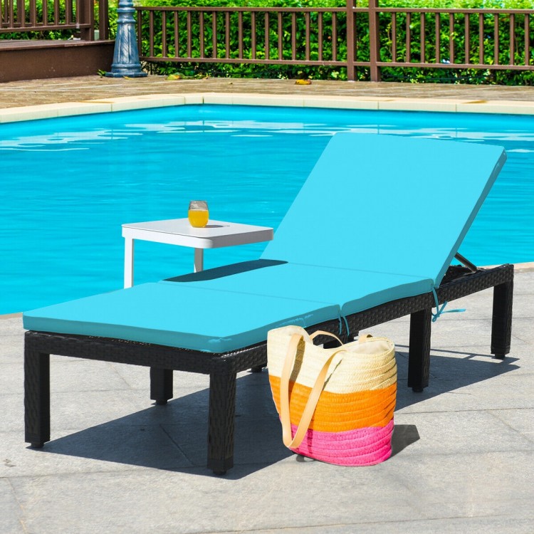 Height adjustable blue cushioned rattan lounge chair by the pool, perfect for outdoor relaxation and comfort.