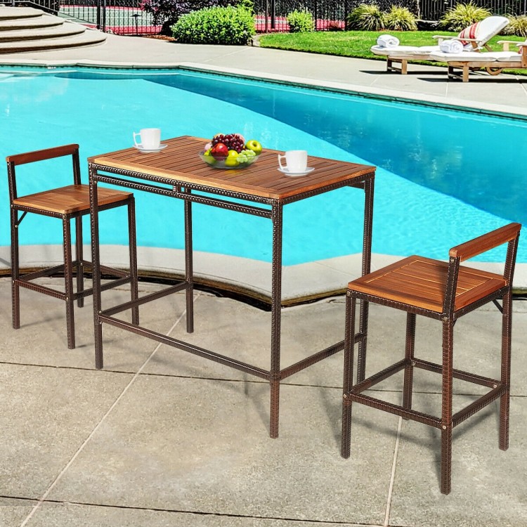 3-piece patio rattan wicker bar dining set with acacia wood top, featuring a table and two chairs for outdoor use.