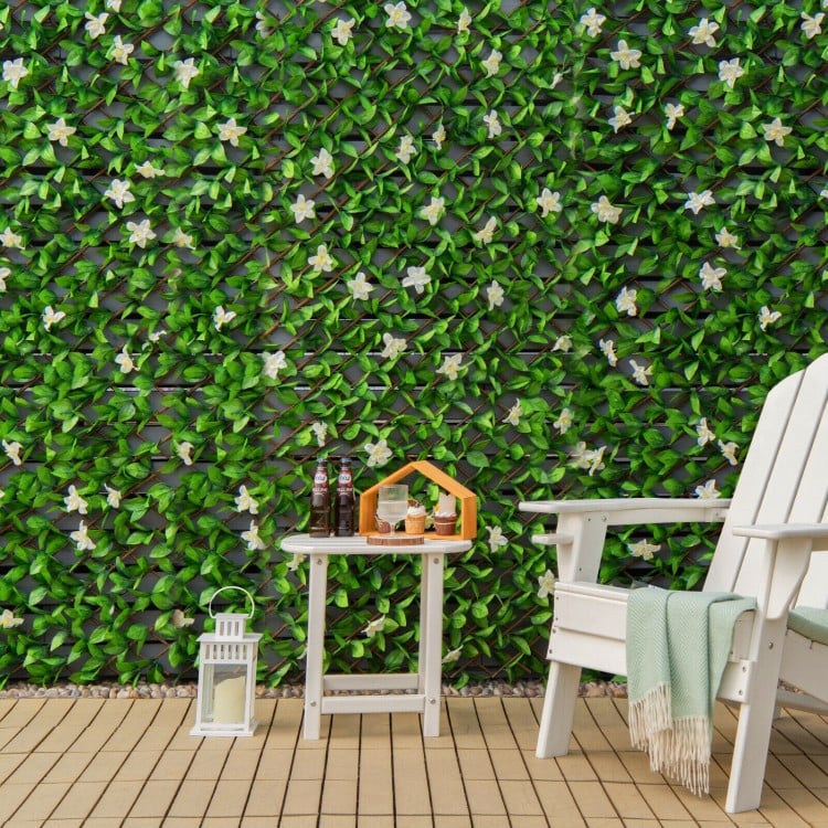 Expandable faux ivy privacy screen fence panel with white flowers, ideal for balcony decoration and privacy protection.