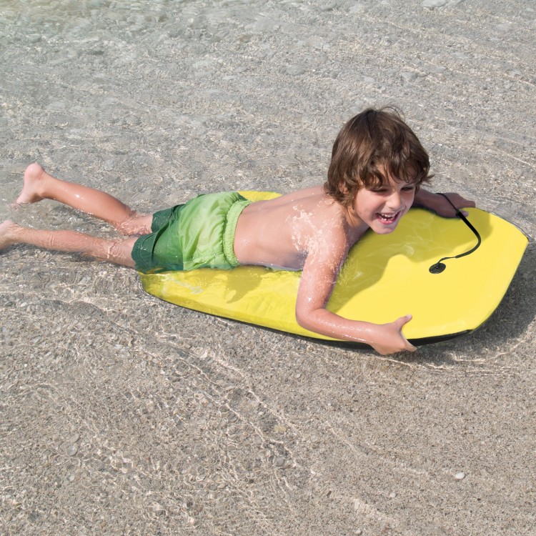 Child riding a bright yellow Super Lightweight Surfing Bodyboard in shallow water, perfect for summer water sports.