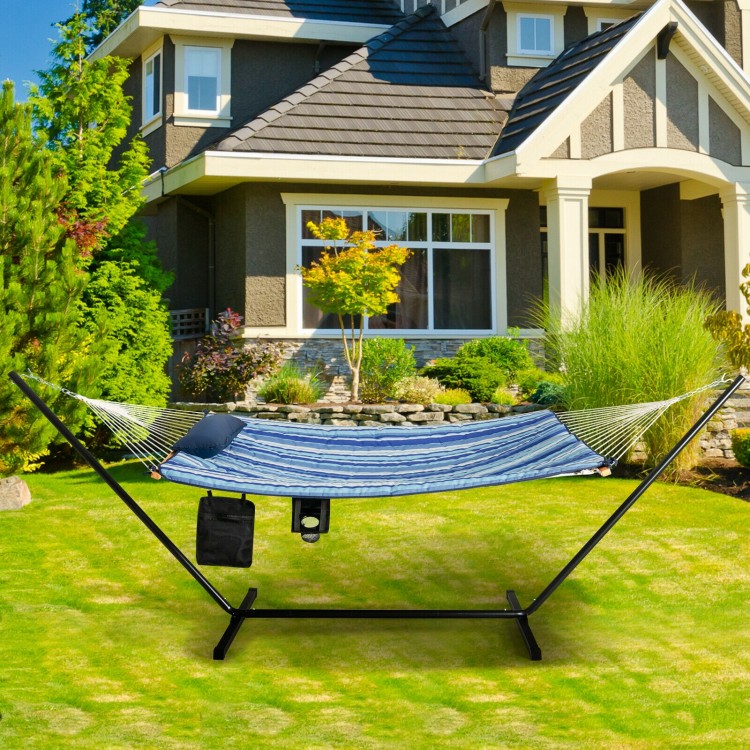 Hammock chair stand set with blue cotton swing, pillow, and cup holder for outdoor relaxation in a stable steel frame.