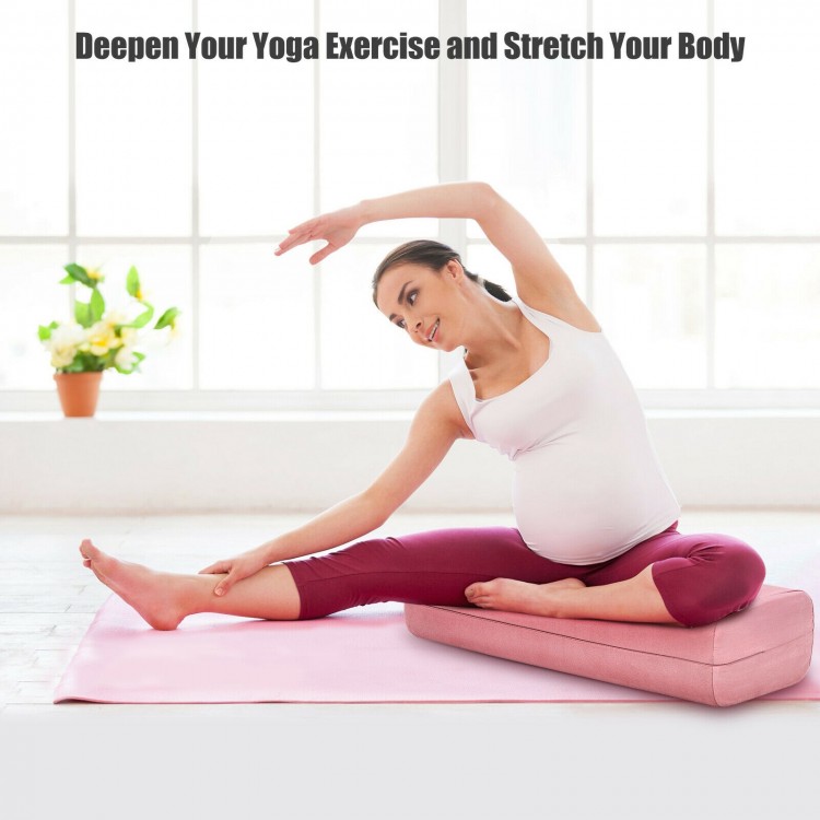 Yoga bolster pillow in pink with removable cover, providing support for yoga exercises and relaxation at home or on the.