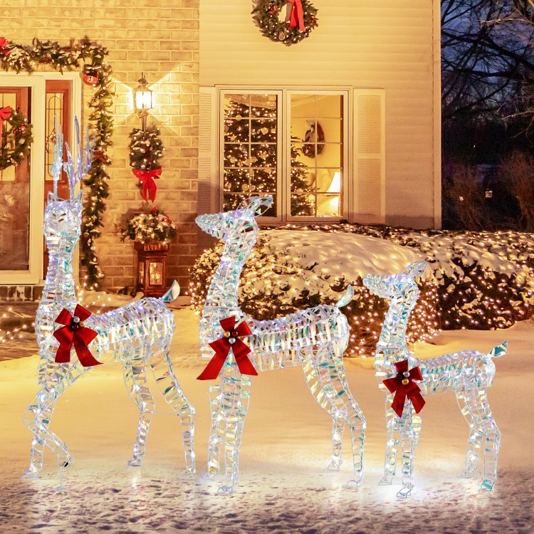 Three lighted Christmas reindeer with festive bows, showcasing a 5 ft buck, 4 ft doe, and 3 ft fawn for holiday cheer.