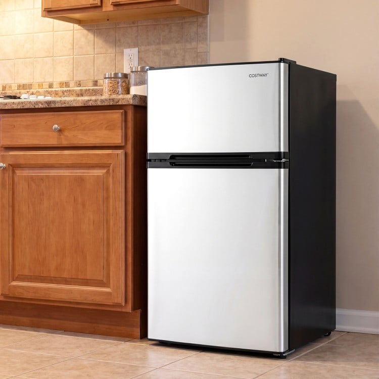 Compact 3.2 cu.ft mini fridge with freezer, adjustable thermostat, and reversible door, perfect for small spaces.