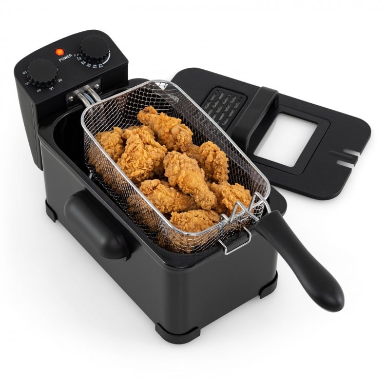 Electric stainless steel deep fryer with 3.2 qt capacity, frying crispy chicken, adjustable temperature, and timer.