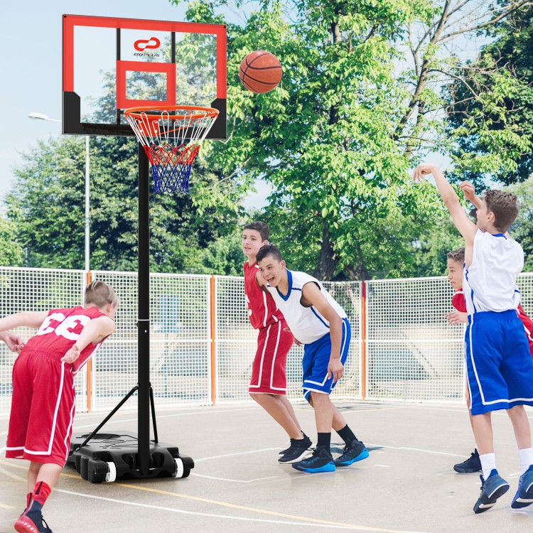 Kids playing basketball with a portable adjustable hoop system, featuring a shatterproof backboard and sturdy base.