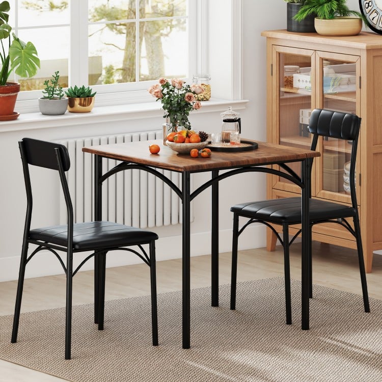 Square dining table set with rustic brown veneer and two black PU leather chairs, perfect for cozy dining rooms.