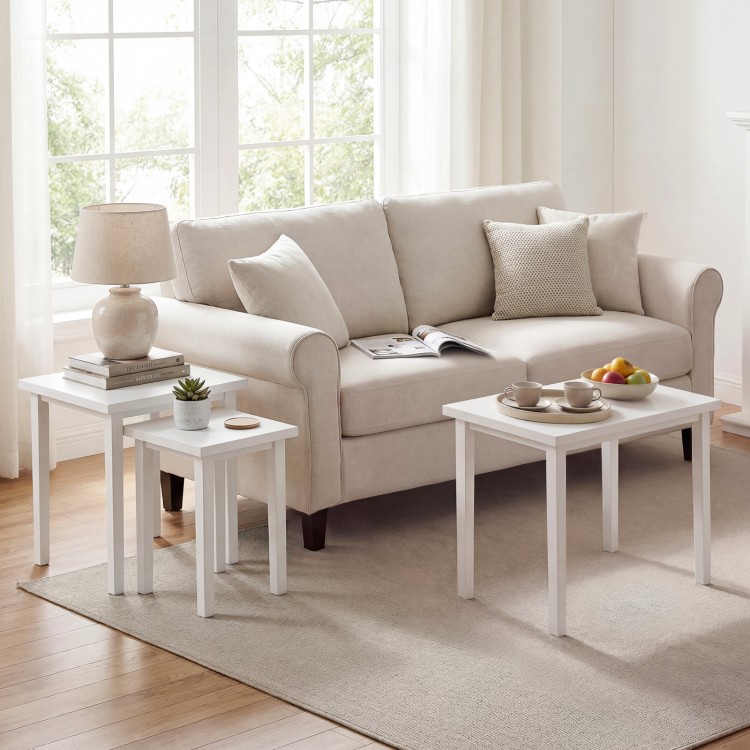 Three-piece white farmhouse side table set with sleek surfaces, perfect for living room use and space-saving nesting.