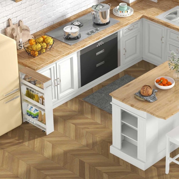 Kitchen island with rubber wood countertop, two bar stools, and narrow storage cart for versatile kitchen organization.