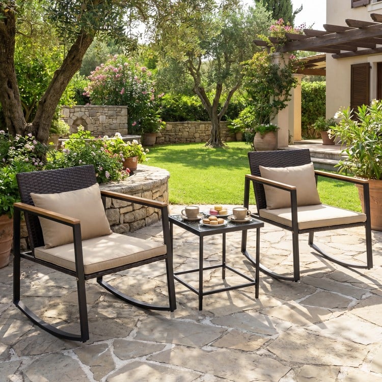 Outdoor rocking chairs with soft cushions and a tempered glass coffee table, perfect for garden relaxation.