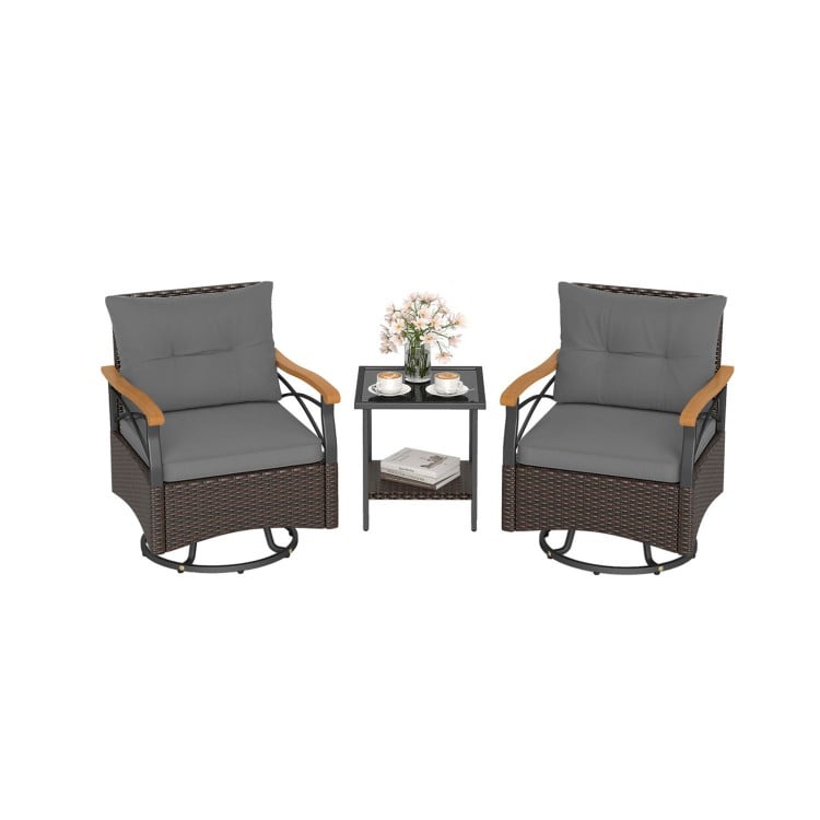 Two gray swivel chairs with acacia wood armrests and a tempered glass side table for outdoor relaxation.