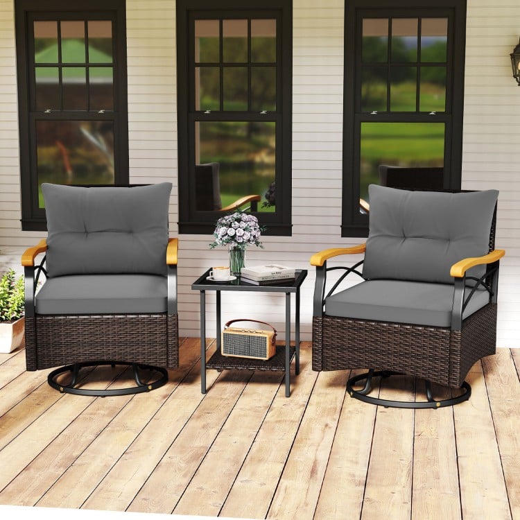Outdoor swivel chair set with gray cushions, acacia wood armrests, and tempered glass side table for backyard.