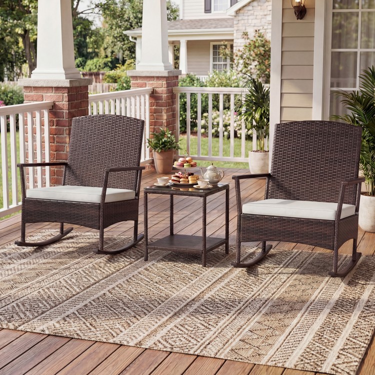 Wicker rocking chairs with off-white cushions and a double-tier coffee table, perfect for outdoor relaxation on the.