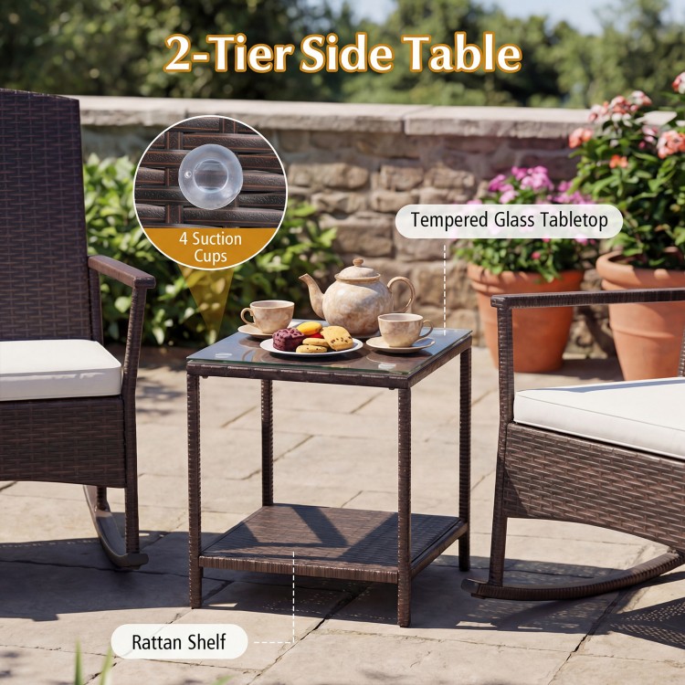 2-tier side table with tempered glass top and rattan shelf, perfect for outdoor patio use with rocking chairs.